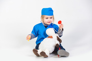 little boy kid works doctor or vet with toy