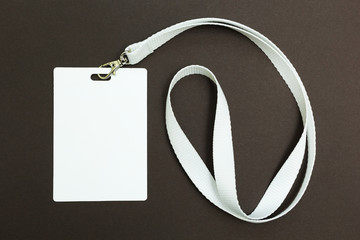 Blank badge or ID pass isolated on brown background, empty space for text.