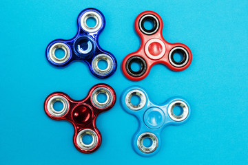 popular fidget spinner toy on blue background