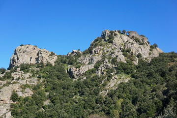 The ruins of the castle of Ultrera at the top of a steep rocky spur of the Massif des Alberes, Pyrenees Orientales, Roussillon, south of France