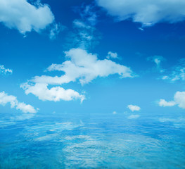 Obraz na płótnie Canvas Infinite water surface over blue sky background