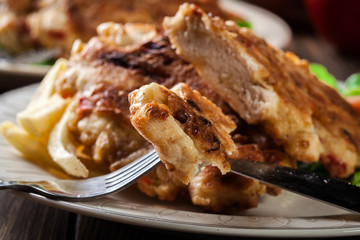 Close up of chicken medallions piece served with chips