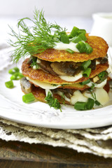 Draniki -potato pancakes with mushrooms and cream sauce.