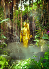 Golden Buddha on green jungle background