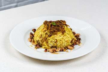 Traditional Middle Eastern fish and fried rice dish with fried pine nuts