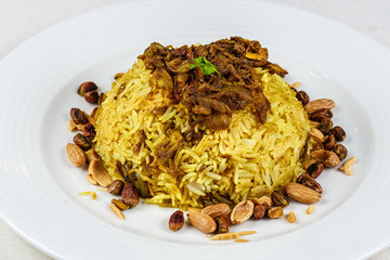 Traditional Middle Eastern fish and fried rice dish with fried pine nuts