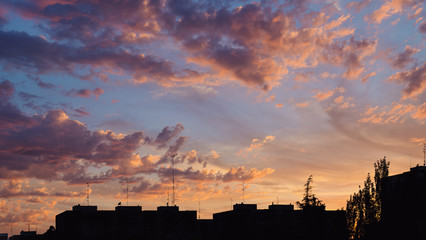 Fototapeta premium Colorful sunset clouds over apartments buildings in Madrid