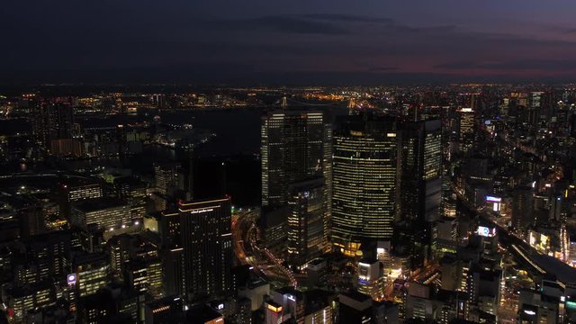 Japan Tokyo Aerial v48 Flying low backwards over downtown Chuo area cityscape views night 2/17