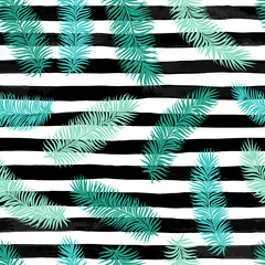 Seamless background with palm leaves on black and white watercolor stripes.