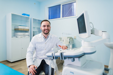 Male doctor with ultrasonic equipment during ultrasound medical examination