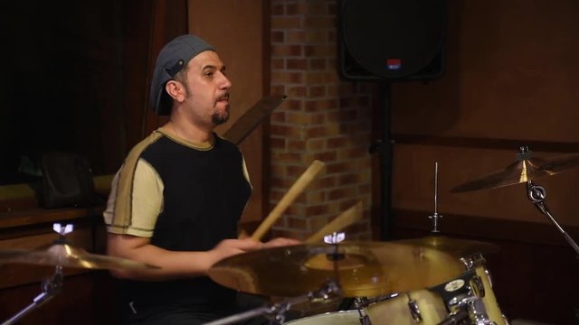 Drum player rehearsal in music recording studio