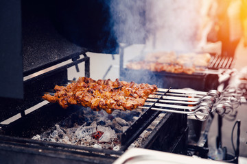 Moist hicken kebabs on the grill in nature. Concept of a family holiday in nature, a meat restaurant, a cafe, cooking meat
