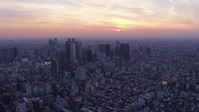 Japan Tokyo Aerial v59 Flying backwards over downtown Shinjuku area cityscape views sunset 2/17