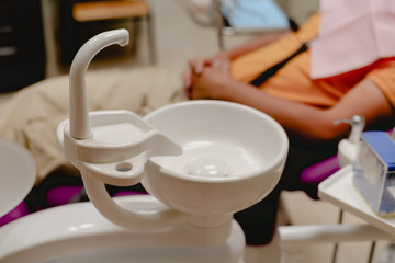 Medical health care treatment procedure. The dentist treats a patient, dental machine office background. Modern dentistry laboratory instrument equipment technology