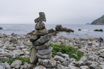 Cairn. Sculpture on the shore of the wild sea