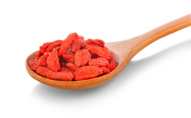 dried goji berries in wood spoon on white background