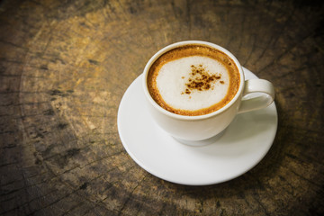 Capuccino on old wood table.