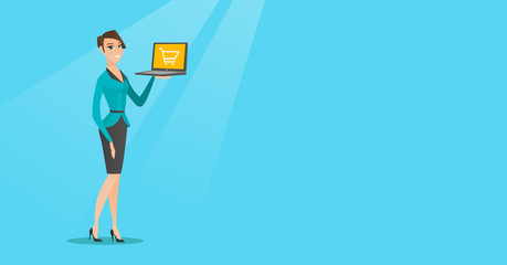 Woman holding laptop with trolley on a screen.