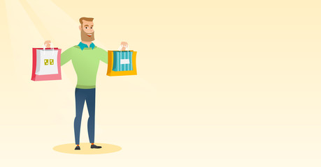 Young caucasian man holding shopping bags.