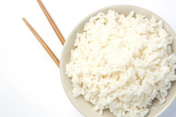 Steamed rice close-up with chopsticks  isolated on a white background with shadow