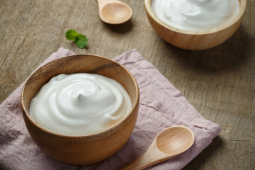 Homemade yogurt or sour cream in a wooden bowl
