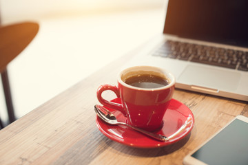 laptop and black coffe in vintage tone