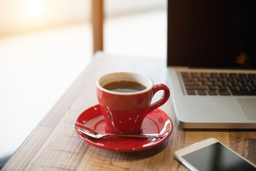 laptop and black coffe in vintage tone