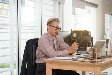 asian business senior male sick at work place