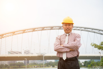 asian senior business architect in safety helmet