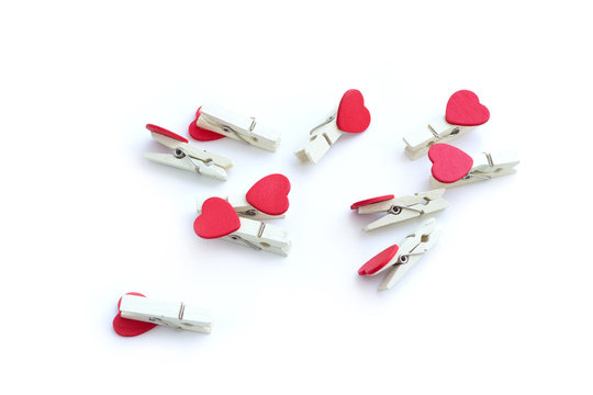 Wooden Clothes Pin Or Cloth Pegs With Heart Shape Design On A White Background