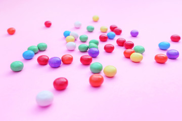 Colorful candies on pink