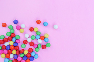 Colorful candies on pink