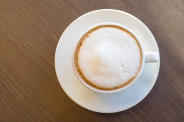 Flat view hot coffee in white cup on the wooden table lifestyle