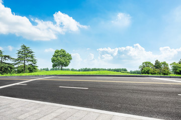 Fototapeta premium asphalt road and green tree in countryside