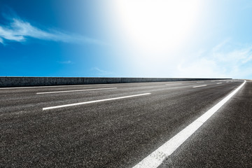 Fototapeta premium Asphalt road and blue sky