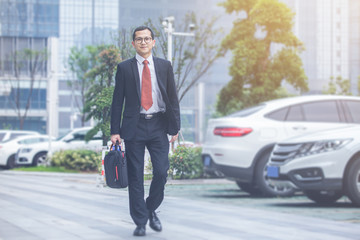 young businessman walking outside office