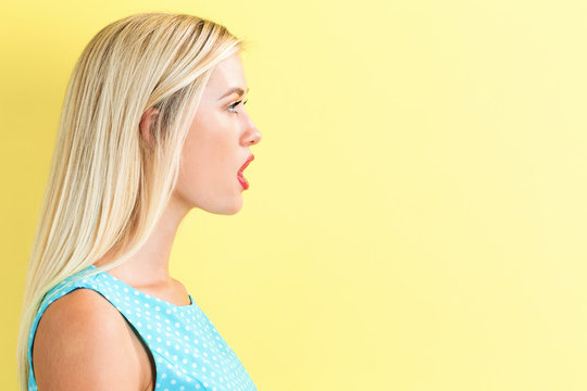 Profile of a young woman on a yellow background