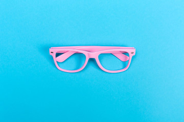 A pair of sunglasses on a bright blue background