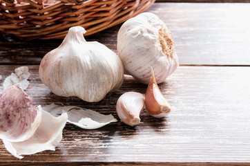 Garlic cloves and garlic bulb on wooden background. Garlic is used as seasoning and as a traditional medicine.Copy space.