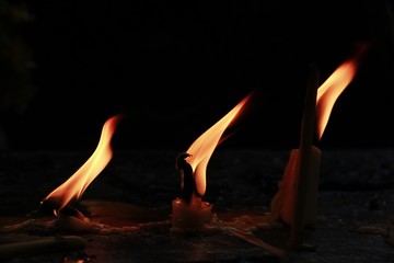 Candles burn when ignited, causing heat to flame, candles and flames.