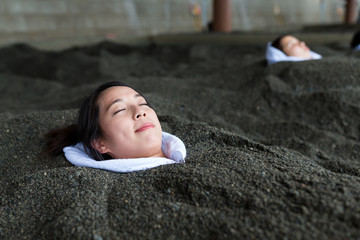 Woman enjoy hot sand bath