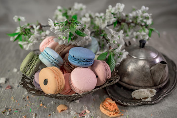 Multicolored macaroons in old eastern braided vase