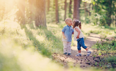 Boy and boy kissing in the forest