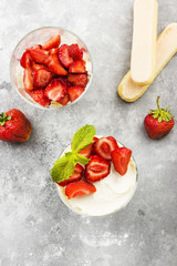 Dessert tiramisu with strawberry on a gray background. Top view. Food background