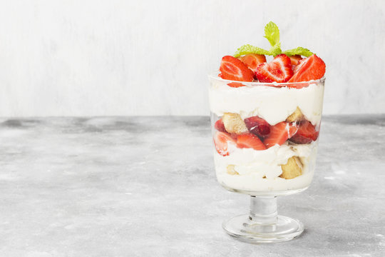 Dessert tiramisu with strawberry on a gray background. Copy space. Food background