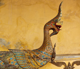 Old wooden Naga sculpture in Lao temple, Laos