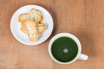 Home made a small sweet cookie with black sesame, typically round, flat, and crisp.Cookie in dish with hot green tea .