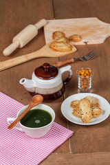 Hot and fresh green tea on wood with home made a small sweet cookie with black sesame.