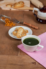 Hot and fresh green tea on wood with home made a small sweet cookie with black sesame.