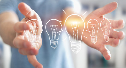 Businessman holding a sketch lightbulb